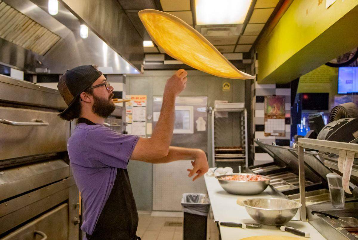Mellow Mushroom employee Josh Mangrum spins pizza dough in the kitchen of Mellow Mushroom Wednesday afternoon in Myrtle Beach.