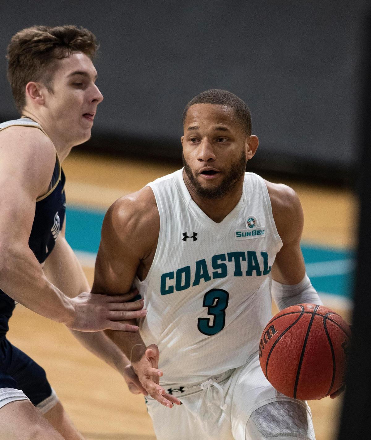 Coastal Carolina guard DeVante Jones (3) drives to the basket against Georgia Southern Sunday at the HTC Center in Conway.
