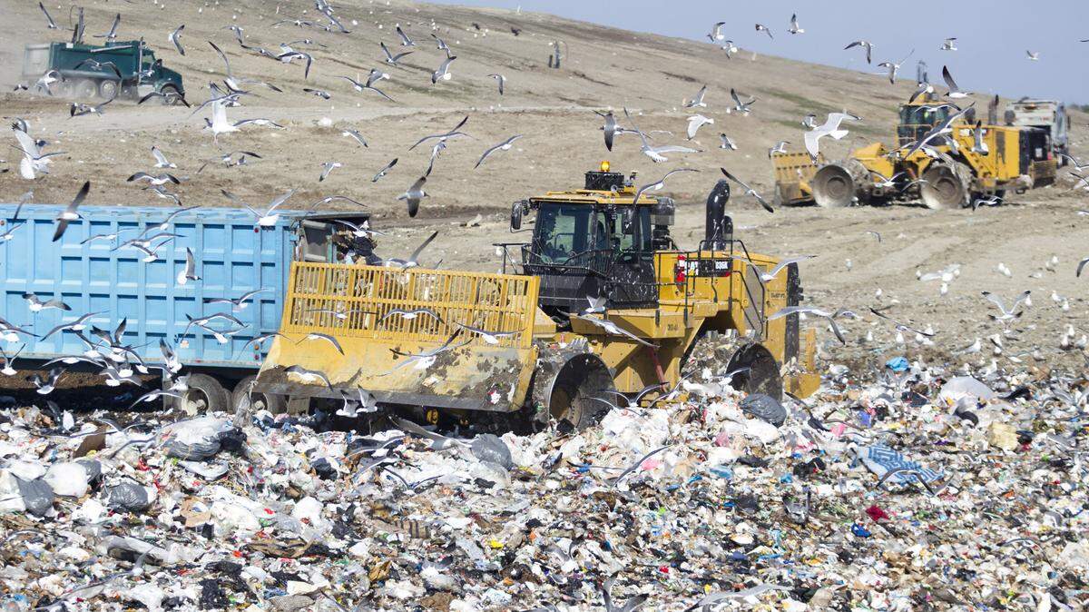 A $1.2 million bulldozer equiped with computers and GPS compacts trash at the Solid Waste Authority's landfill on Highway 90.
