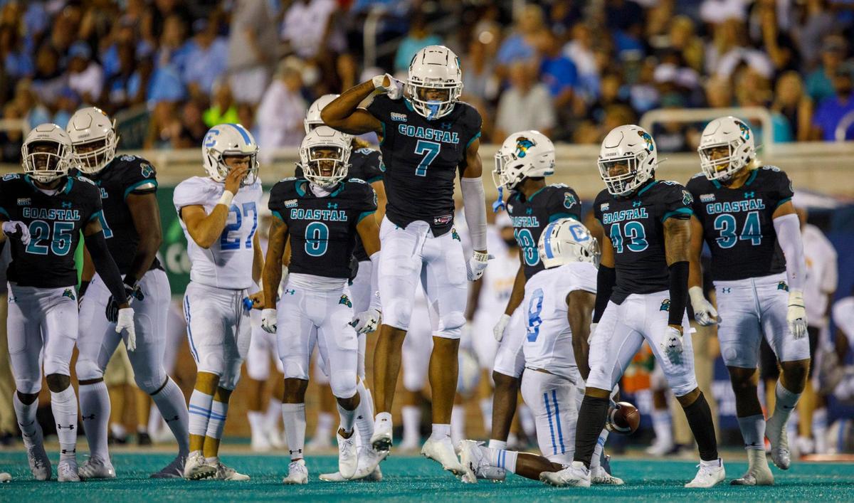 Coastal defenders celebrate a tackle against The Citadel. Coastal Carolina University hosted The Citadel in game one of the 2021-22 season. Aug. 11, 2021.