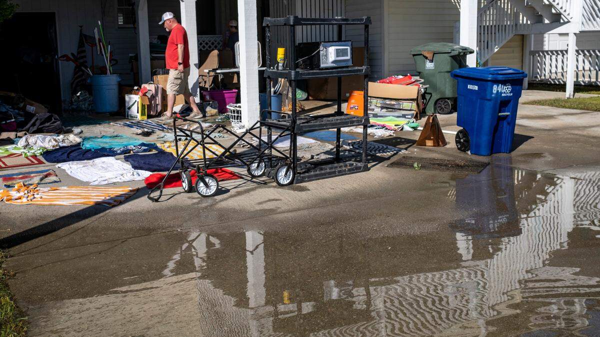 Isaac Tyndall pulls his belongings from the flooded lower level of his home on 58th Avenue North in the Cherry Grove Community of North Myrtle Beach, S.C. on Saturday. The Cherry Grove community in North Myrtle Beach received the brunt of Hurricane Ian’s storm surge and was assessing damage and cleaning up on Saturday, October 1, 2022.
