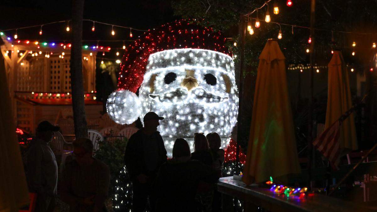 The Murrells Inlet Marshwalk, lit with holiday displays, has become a destination for visitors to walk it’s half mile length, taking in the lights, food and music from it’s eight waterfront restaurants this Christmas season. November 30, 2022.