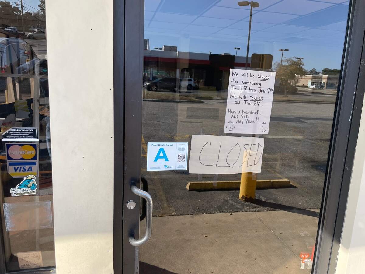 A sign hung in the front door of Maryland Fried Chicken in Conway, SC.