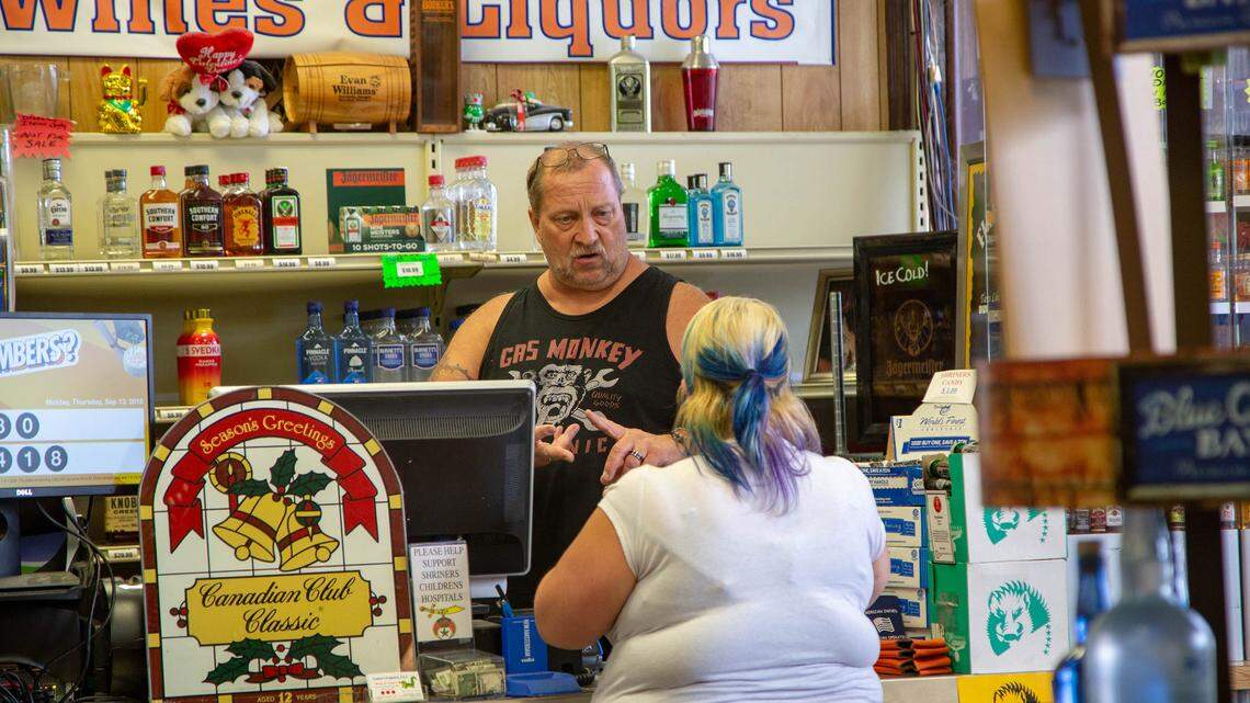 Robert Pereksta, owner of Gator’s Liquors in Surfside Beach, talks with a customer at the store on Thursday. Pereksta says he plans to reopen again Saturday.