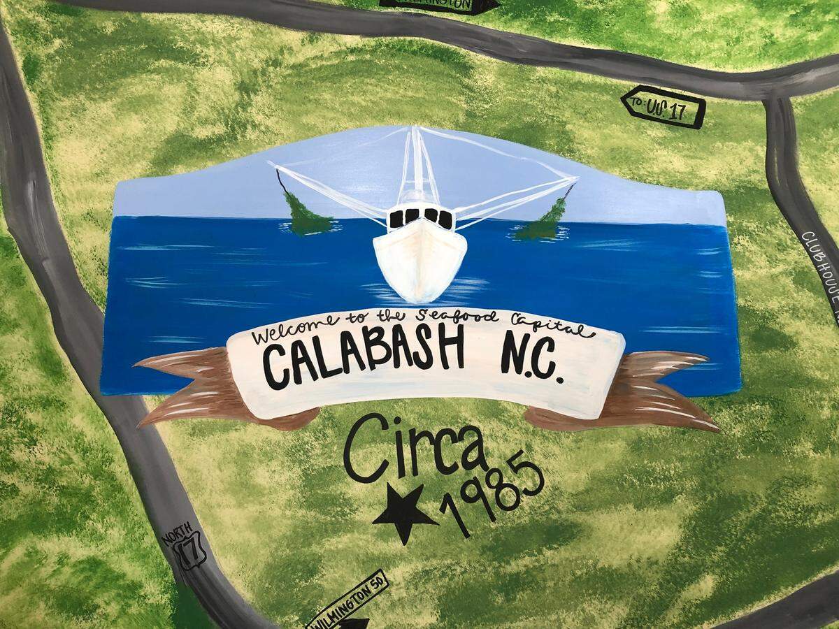 A mural in the dining room of Beck’s Restaurant in Calabash, NC says, “Welcome to the seafood capital.” Calabash-style fried fish can be found in North and South Carolina and beyond. TSN August 2, 2023 File.