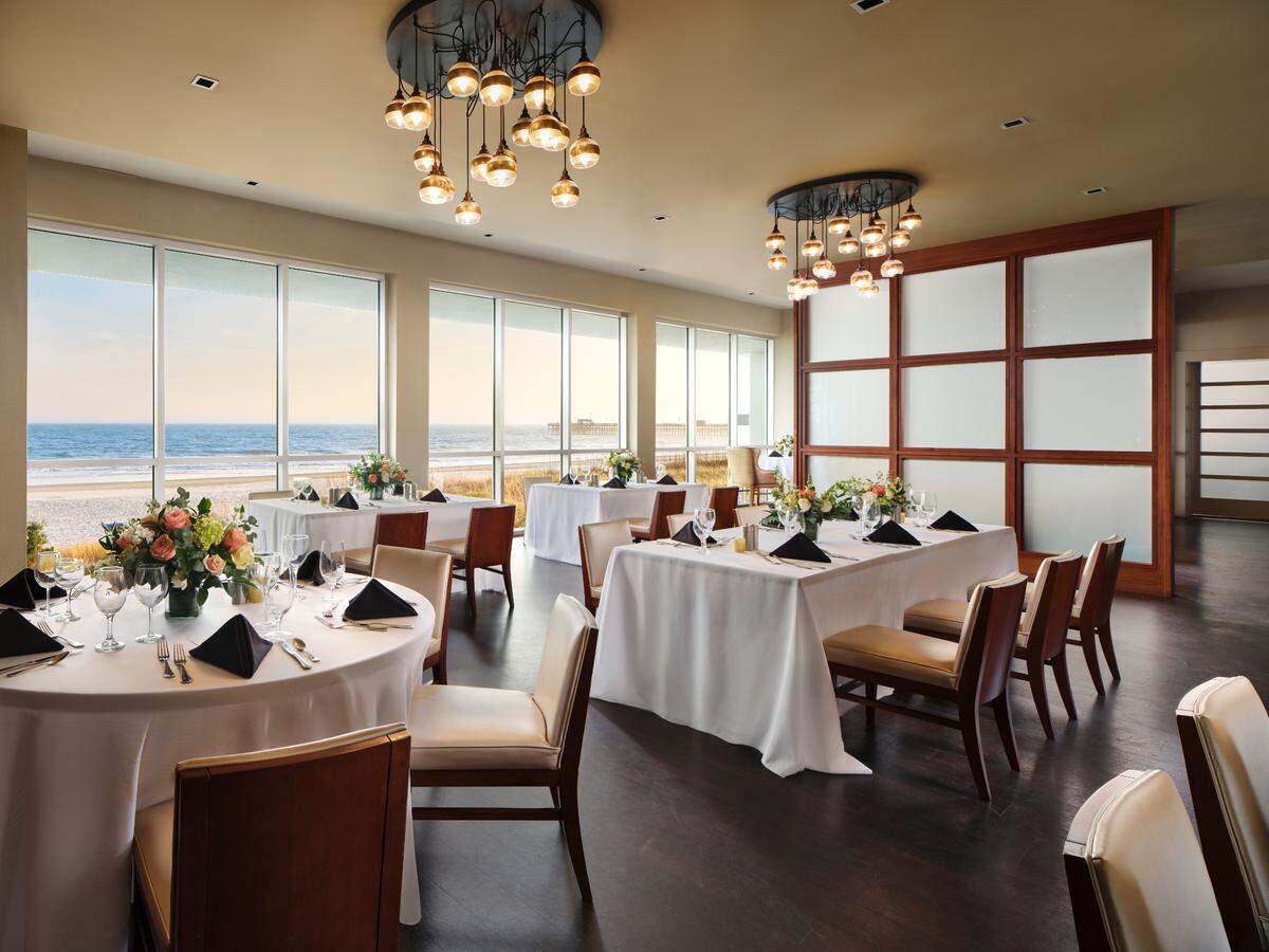 A dining space in the Embassy Suites by Hilton Myrtle Beach Oceanfront Resort.