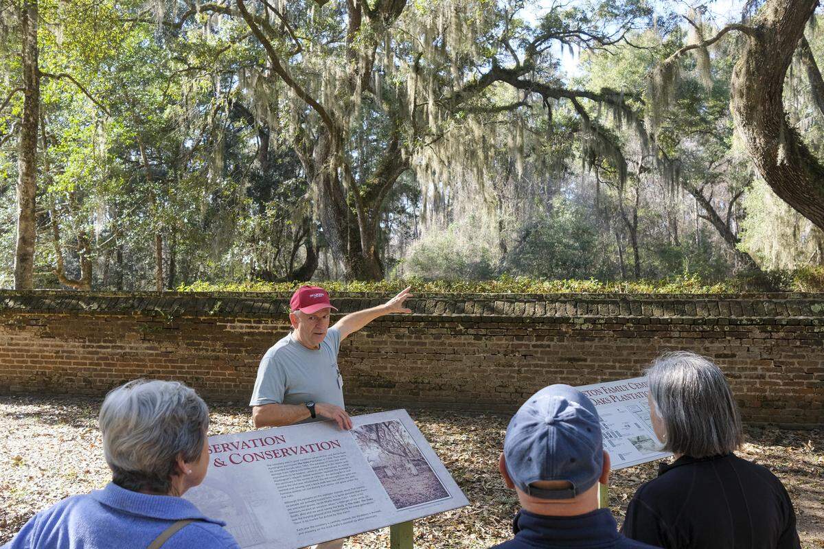 Tom Broderick guides a tour group through the Alston Family Cemetery at The Oaks Plantation within Brookgreen Gardens on Jan. 7. The ‘Silent Cities’ tours have resumed at Brookgreen Gardens, where visitors can learn about the history of the plantations on the site and the burial customs of both the plantation owners and the enslaved people that once lived in the area.
