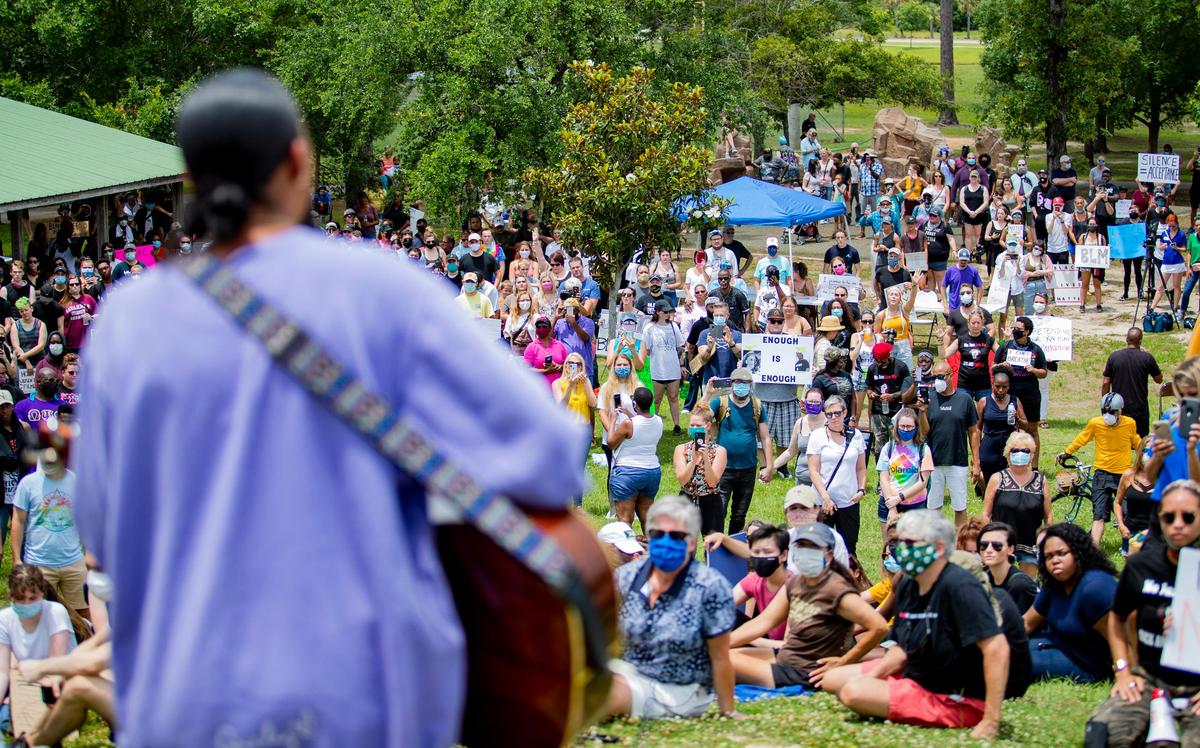 Conway High School graduate Cecily Hennigan performs for protesters atop a hill in Market Common’s Grand Park during a Black Lives Matter rally Sunday afternoon.