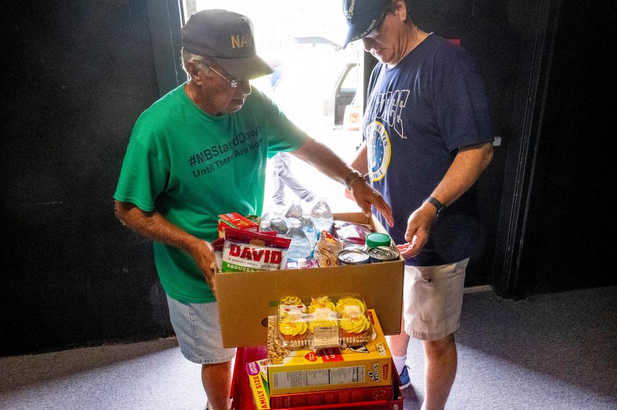 Veterans load boxes of food into a waiting car at the The Socastee Food Pantry. The pantry is a veteran run food source in the Socastee community. The pantry is a part of Faith Outreach Ministries, which facilitates food distribution events each month in Horry County. June 23, 2021.