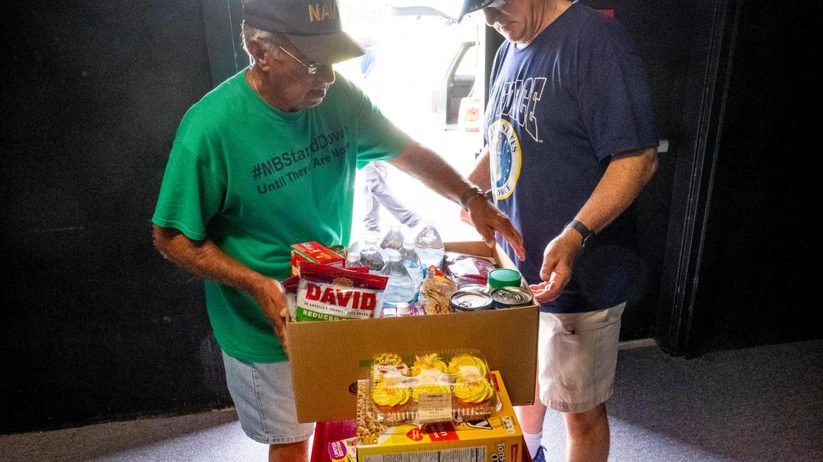Volunteers load boxes of food into a waiting car at the Socastee Food Pantry. June 23, 2021.