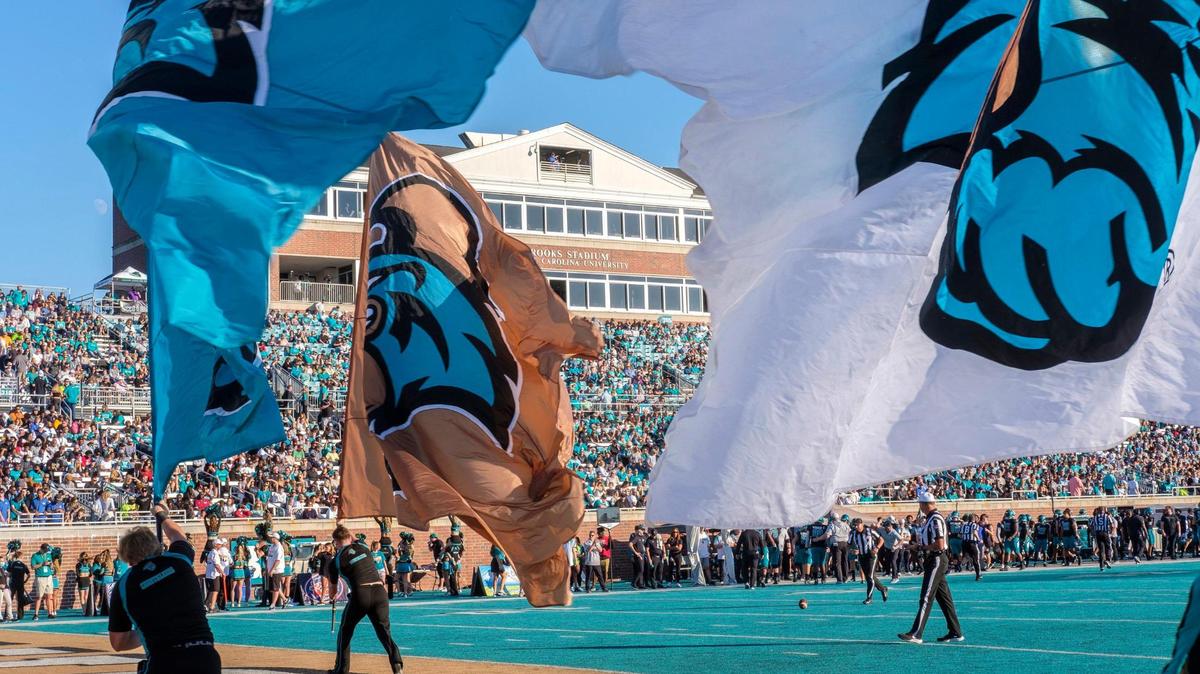 Coastal Carolina flags fly at Brooks Stadium after a touchdown against Georgia State during Homecoming on Nov. 13, 2021.