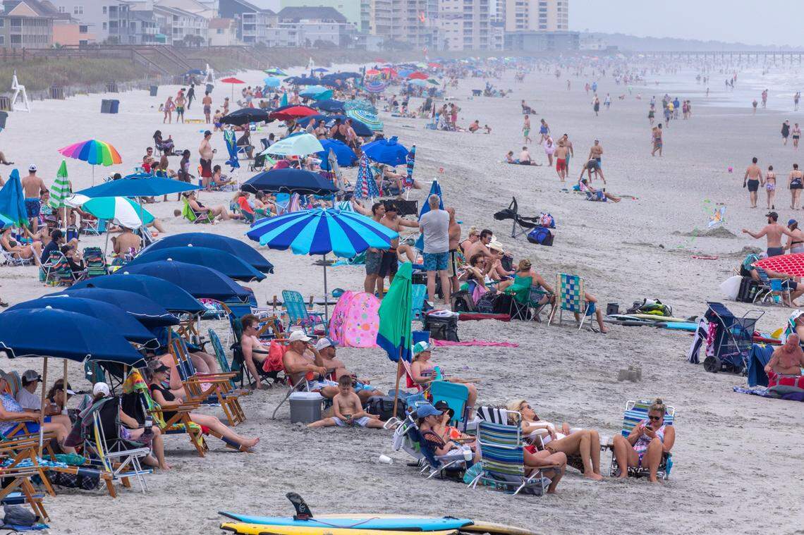 Beachgoers pack the beach in the Cherry Grove section o North Myrtle Beach. On boats, beaches and the boulevards, tourists and residents enjoy the first days of the summer season on the Grand Strand during Memorial Day weekend 2021. May 29, 2021.