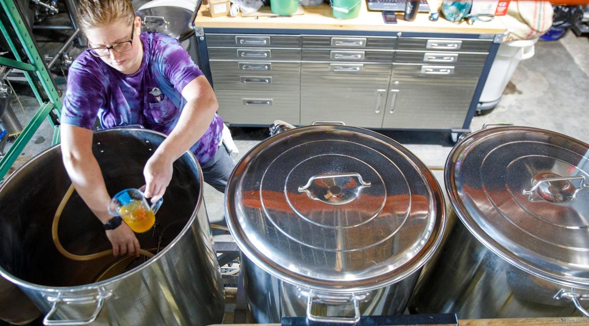 Jordan Skeen, a brewer at Tidal Creek Brewhouse prepares pilot batch of a new beer. Oct. 5, 2021.