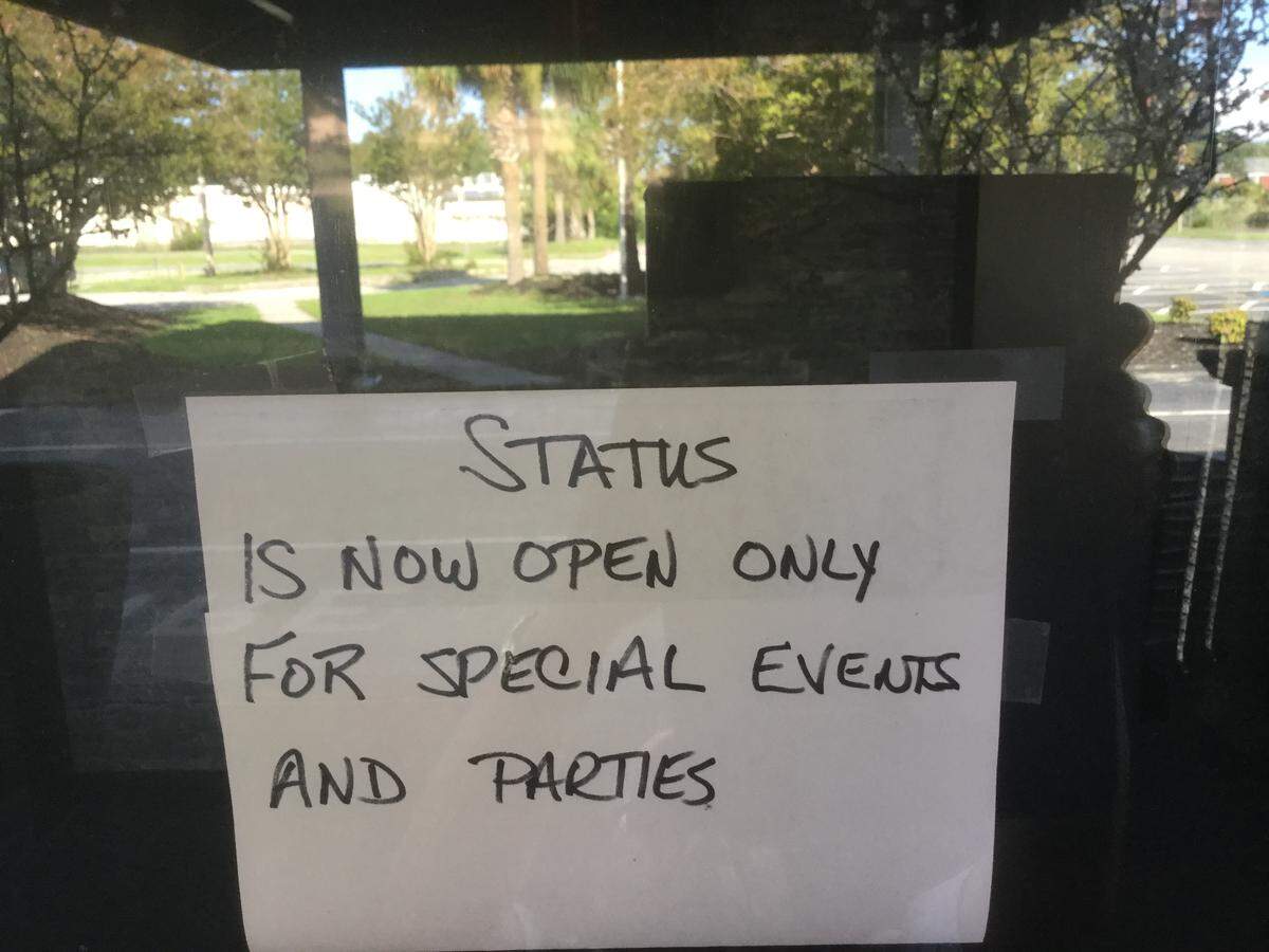 A sign on the Status Nightlife front entrance door states it is open only for special events and parties.