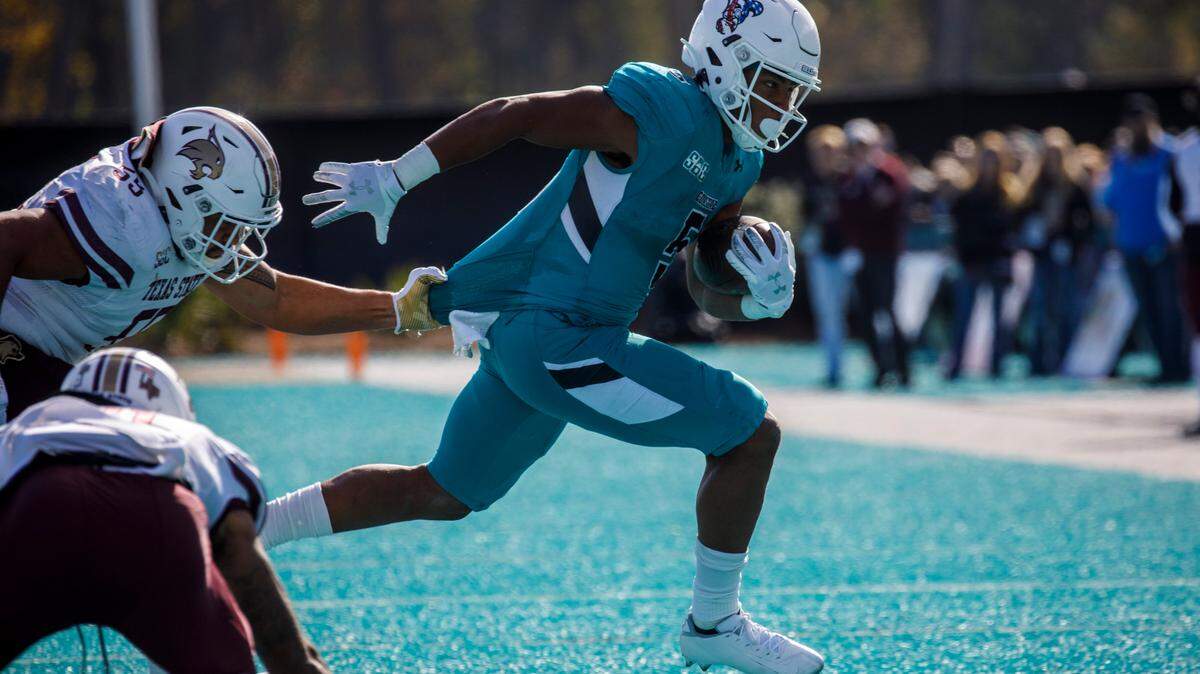 Coastal’s Shermari Jones dodges Texas State defenders on Saturday. Coastal Carolina played Texas State in college football. The Coastal Carolina Chanticleers played the Texas State Bobcats in a Sun Belt Conference NCAA FBS college football game in Conway SC. Nov. 20, 2021.