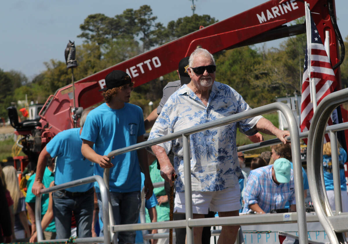 Captain Archie Neil 'Poo' McLauchlin exists the barge that served as a stage during the dedication of the swing bridge in Little River that was renamed in his honor.