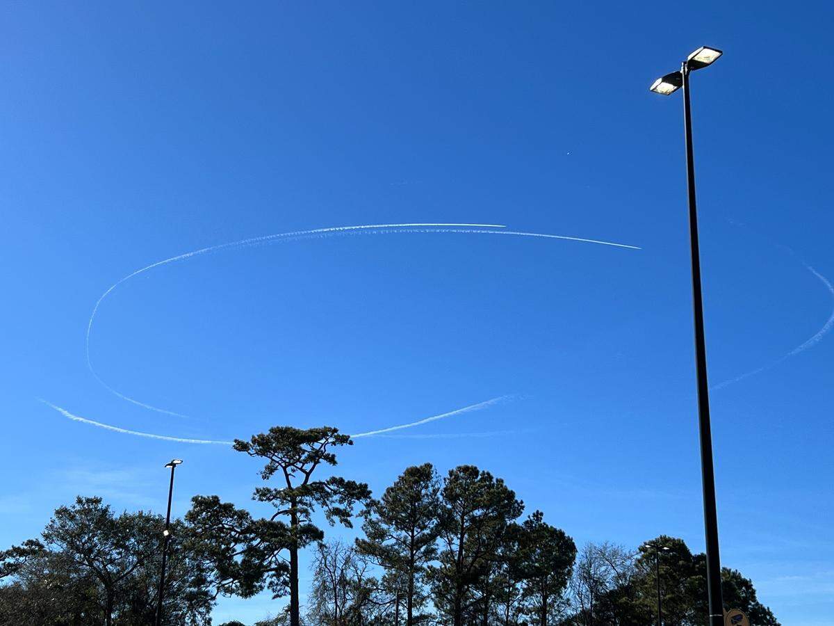 Contrails of military jets circle what is believed to be a Chinese spy balloon as it passes over North Myrtle Beach, S.C. Feb. 4, 2023