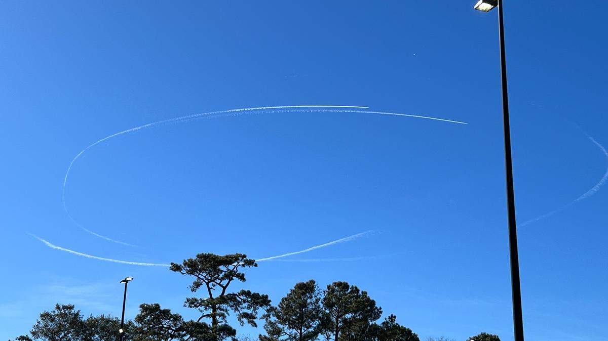 Contrails of military jets circle what is believed to be a Chinese spy balloon as it passes over North Myrtle Beach, S.C. Feb. 4, 2023