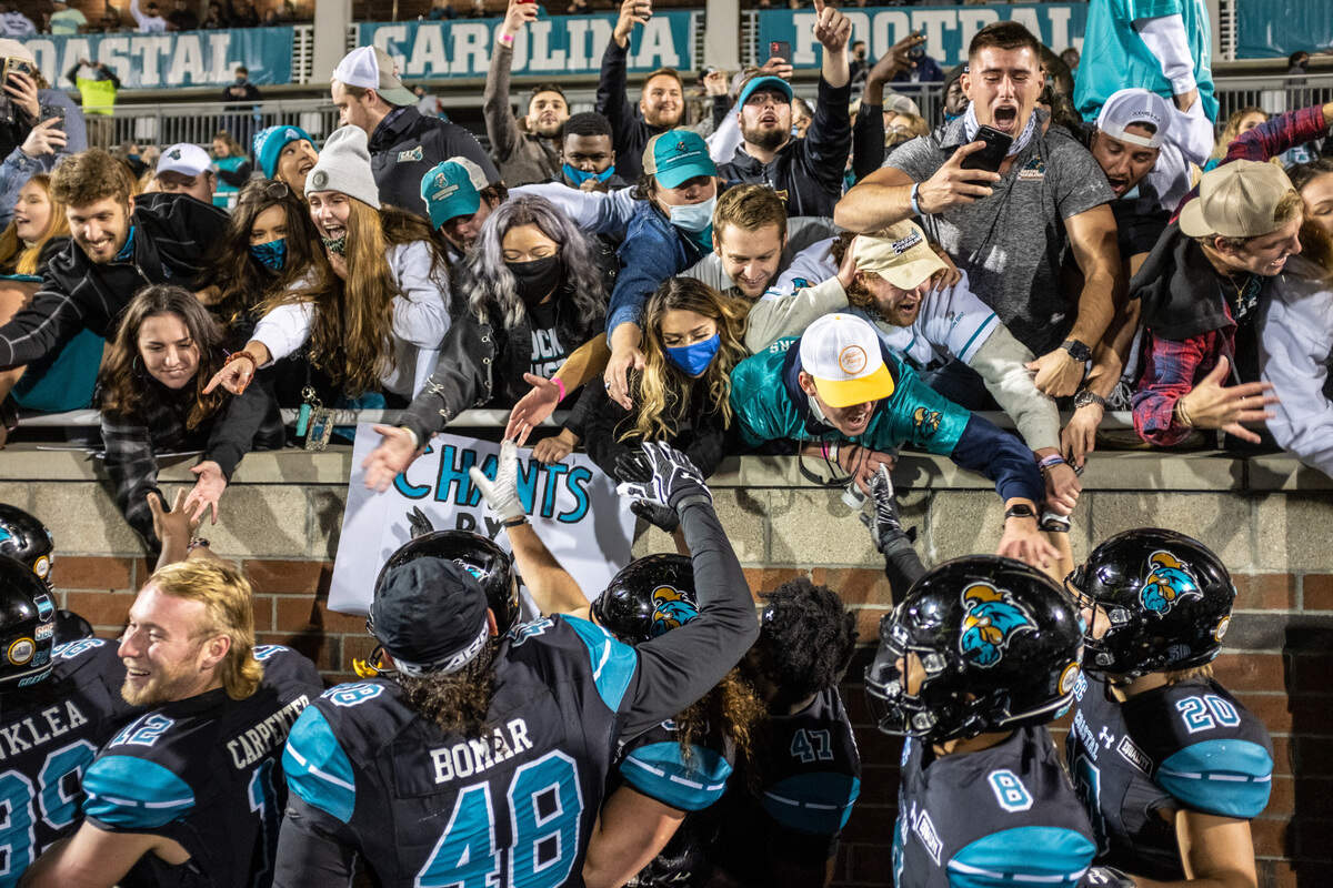 Coastal players and fans celebrate their 22-17 win over Brigham Young at Brooks Stadium in Conway, S.C. December 5, 2020.