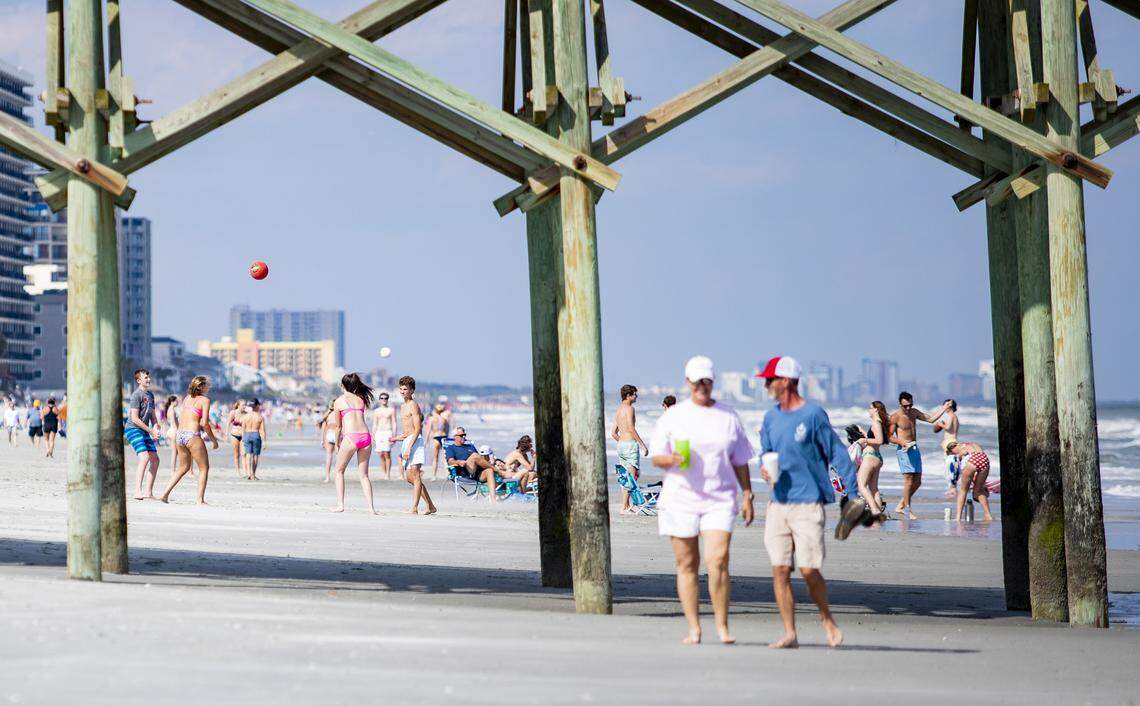 Groups gather on the beach near the Garden City Pier Tuesday afternoon in Garden City.