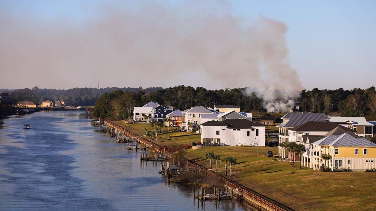 Clouds of smoke are rising from the edge of the woods just off of U.S. 17 Bypass on Tuesday, Oct. 30, 2018.