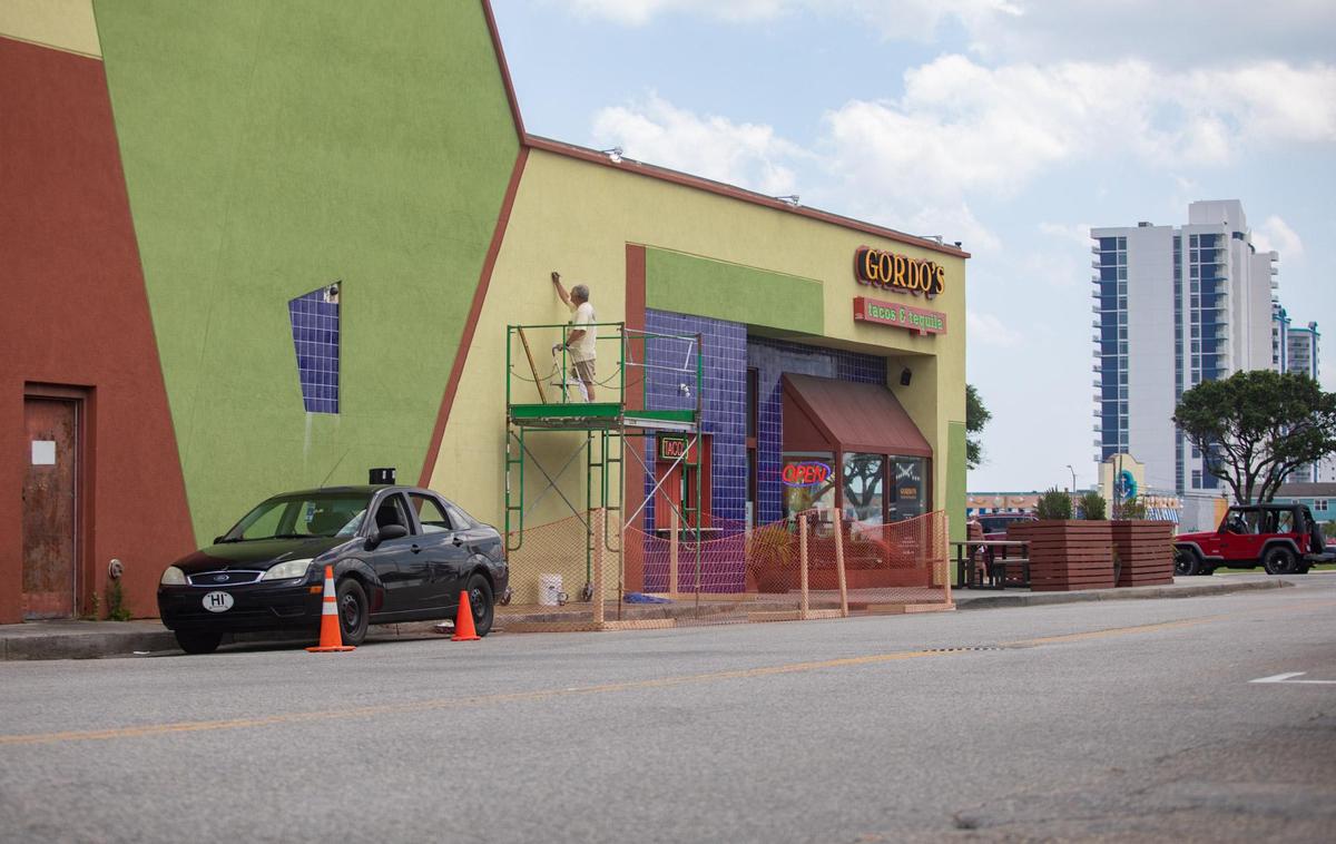 Rick Forest of Little River sketches out a mural on the side wall of Gordo’s Tacos & Tequila Monday afternoon in Myrtle Beach.