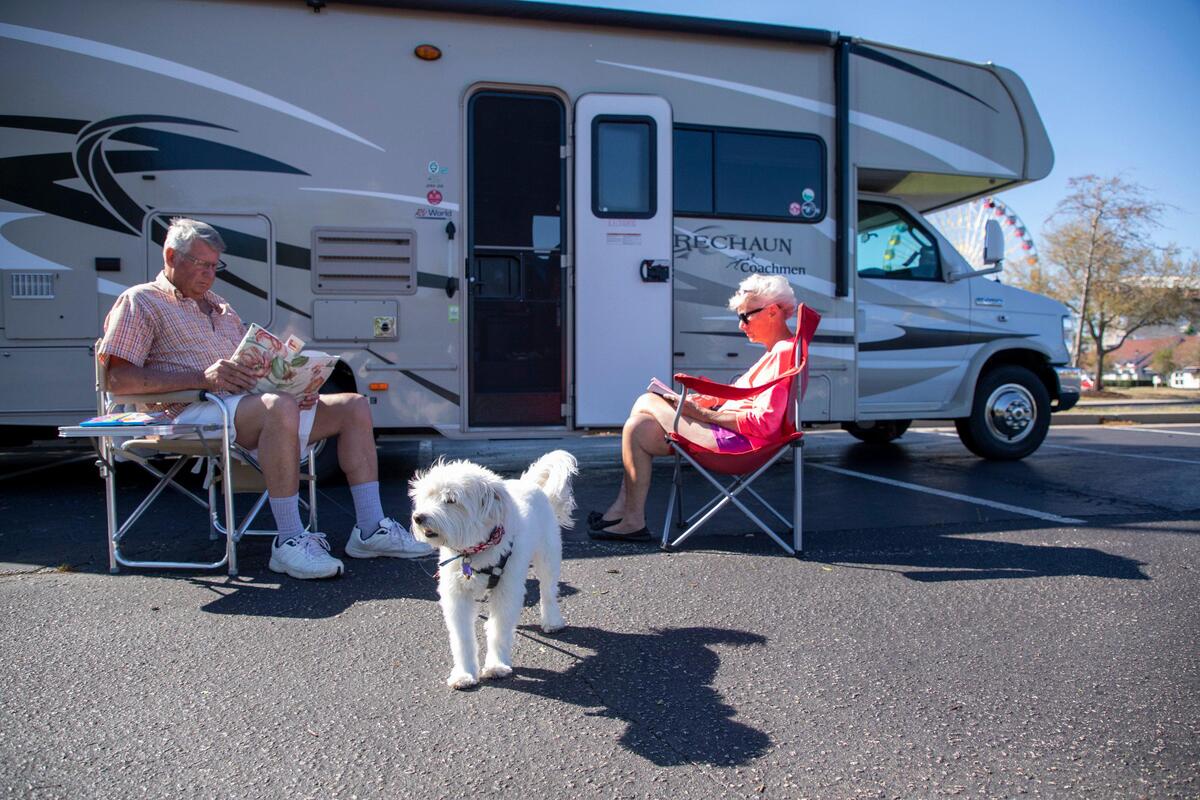 Alan and Dianne Cotton sit in the sun beside their camper parked at Broadway at the Beach. Campers that failed to arrive in the Myrtle Beach area before March 1, were faced with the decision of whether to return home or stay in the area with fewer resources available. The Cottons know they will be quarantined when they return to New Brunswick, Canada so they have chosen to stay and enjoy the weather. April 2, 2020