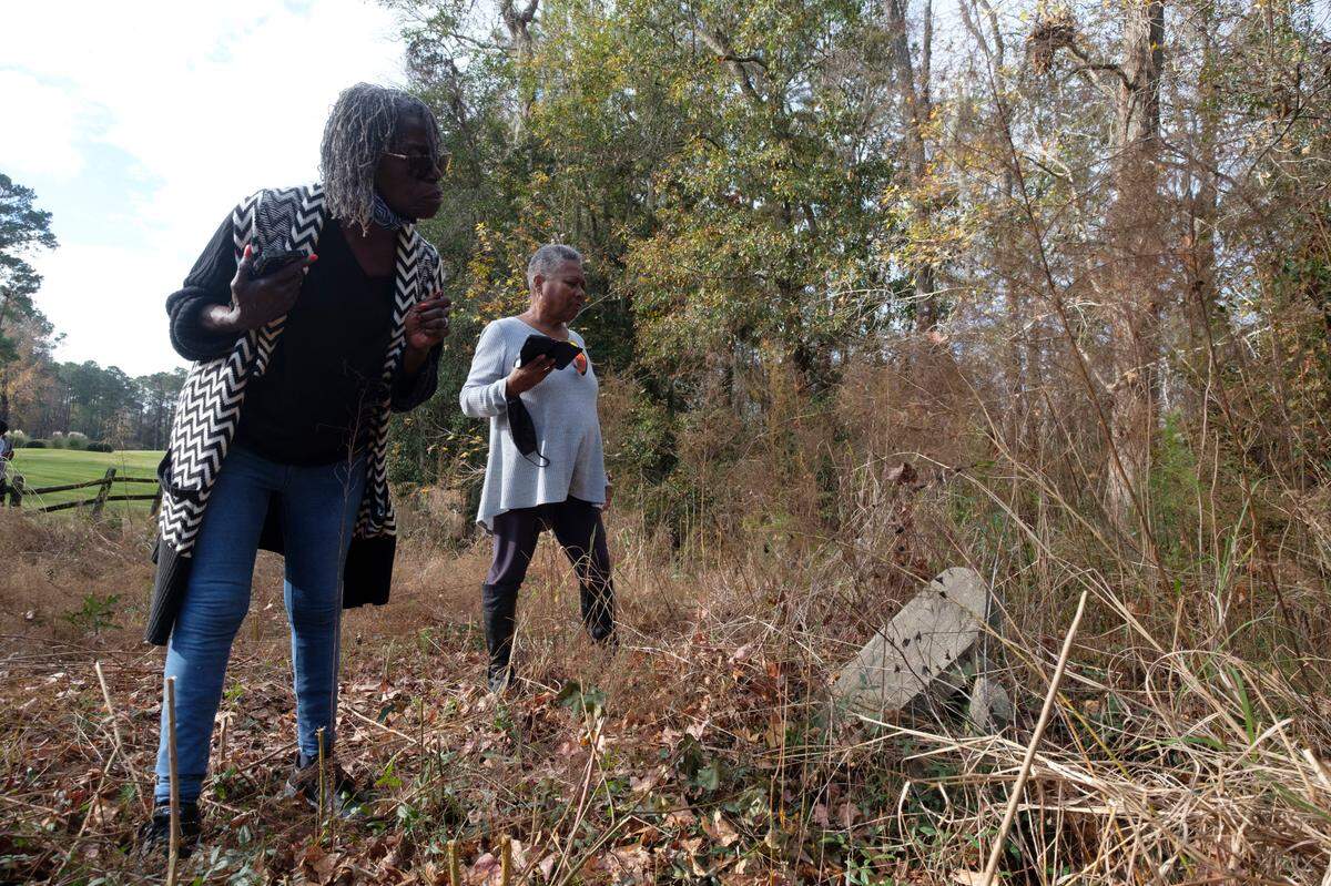 Veronica Gerald Floyd, professor emeritus of English at CCU, finds the broken gravestone of her ancestor Henry Days buried near Blackmoor. Much of the Burgess and Freewoods areas were once home to slave plantations. Some local residents fear there could be more graves of former slaves throughout the area that may be disturbed by the continued growth. Dec. 15, 2021.
