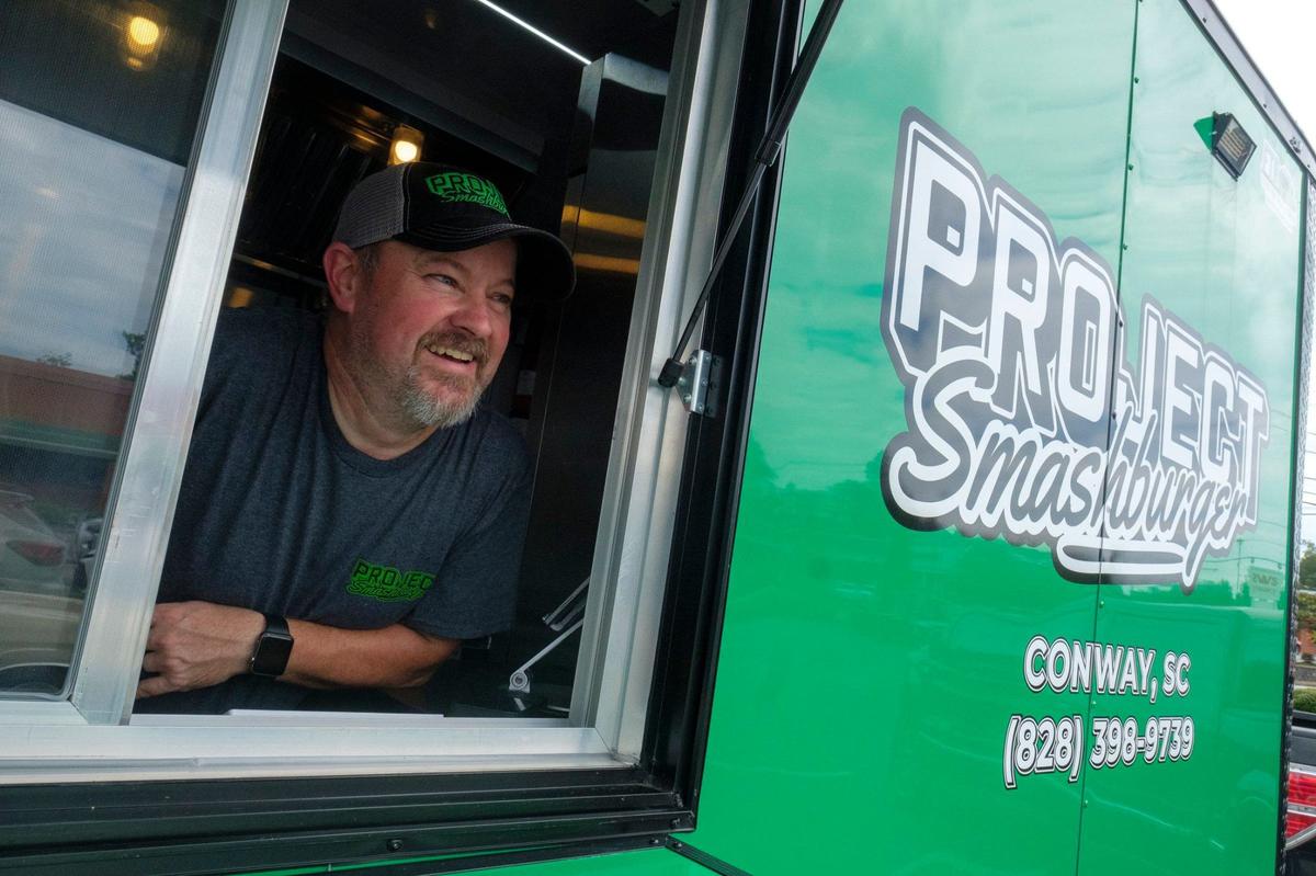 Mike Hensley opened Project Smashburger, a new food truck in Conway, earlier in July and has been met with rave reviews and increasing popularity. He serves smash burgers and loaded fries, usually from the parking lot of Rob’s Auto Body. July 18, 2024.