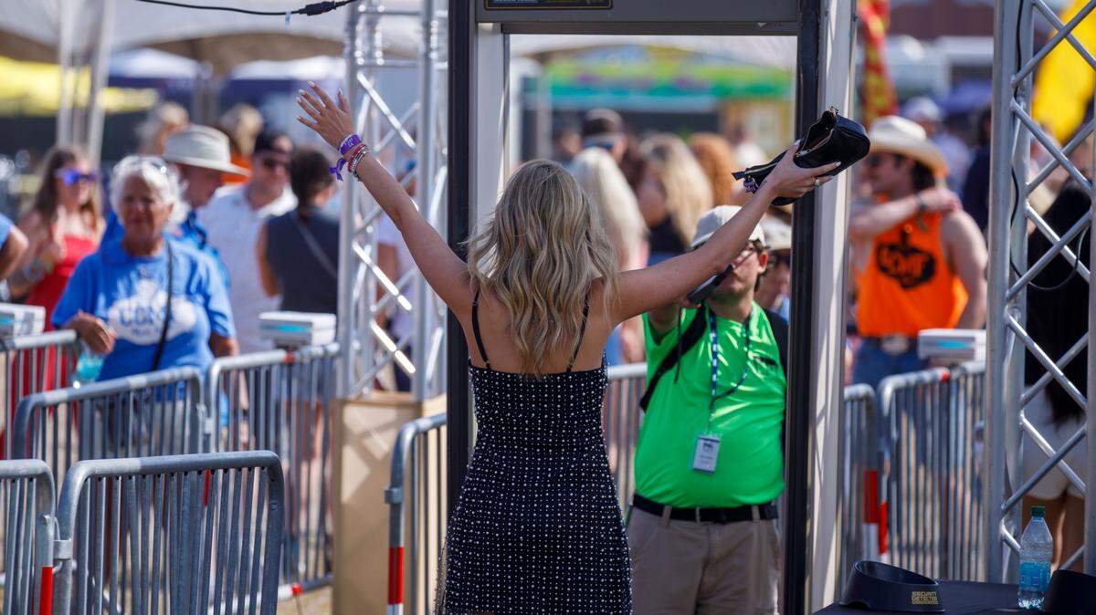 Attendees pass through security checkpoints on the way in to Carolina Country Music Fest. Country music fans arrive for the first night Carolina Country Music Fest 2024. The four day event is expected to draw 30,000 each night at the Burroughs and Chapin Pavilion Place in Myrtle Beach, S.C. Thursday, June 6, 2024.