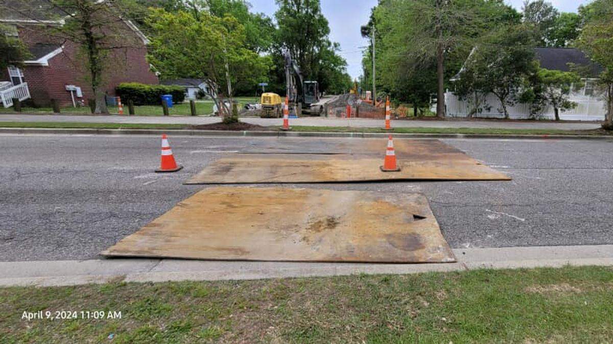 Robert M. Grissom Parkway with pieces of wood over the pavement. The pavement collapsed and the city is repairing it.