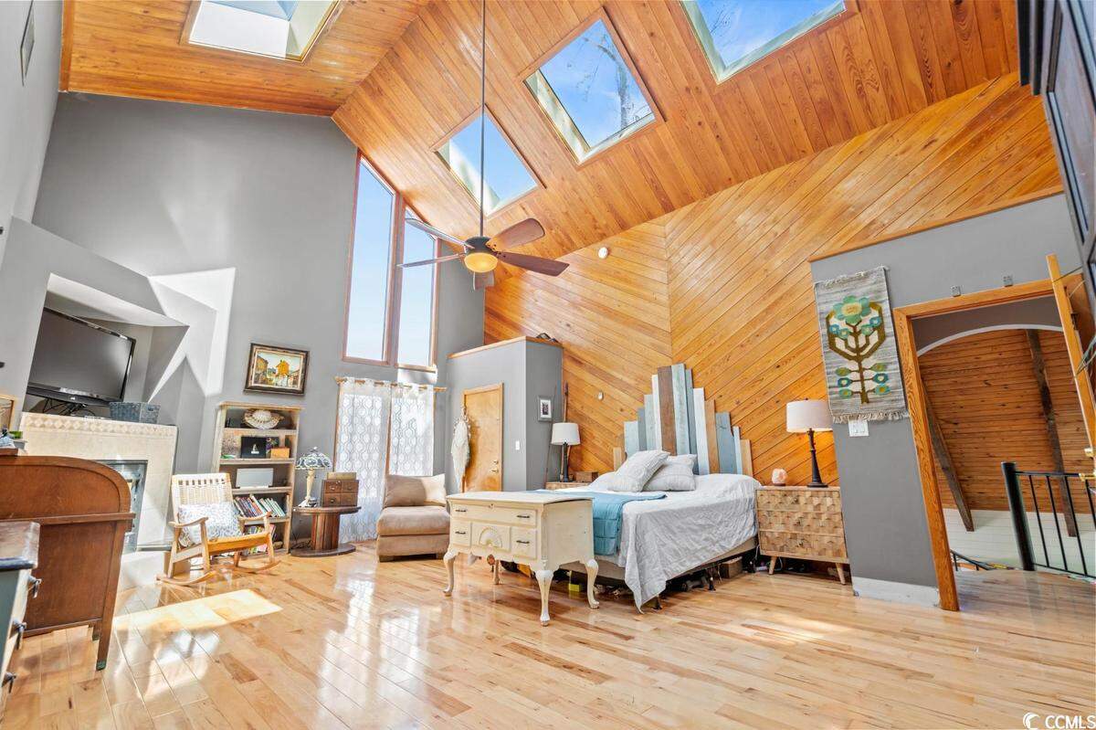 A home surrounded by trees and overlooking the Intracoastal Waterway near North Myrtle Beach is listed for $825,000. Built in 1979, the house has three bedrooms and a dock. Provided photo. Dec. 12, 2023.