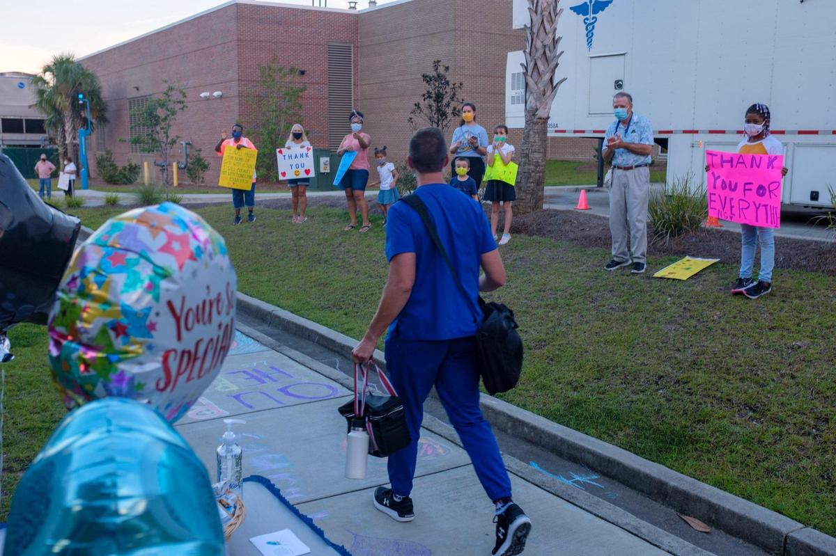 Members of the Georgetown Church of Christ lined up outside Tidelands Georgetown Hospital to honor health care workers during their shift change last night. As COVID-19 cases again surge, hospitals are struggling to keep up with the increase of cases. Tuesday, August 24, 2021.