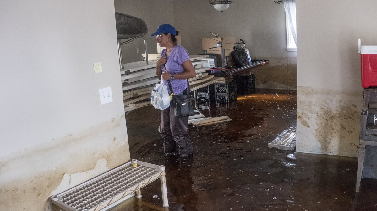 Suzy Centeno Hanson wades into her Rosewood home for the first time since abandoning it to rising flood waters. Hanson was also flooded in the 2016 flood waters of Hurricane Matthew. 
While much of the Rosewood community in Socastee in still under water from Hurricane Florence’s flooding, a few residents were able to return to assess the damage and begin cleaning on Tuesday October 2, 2018.