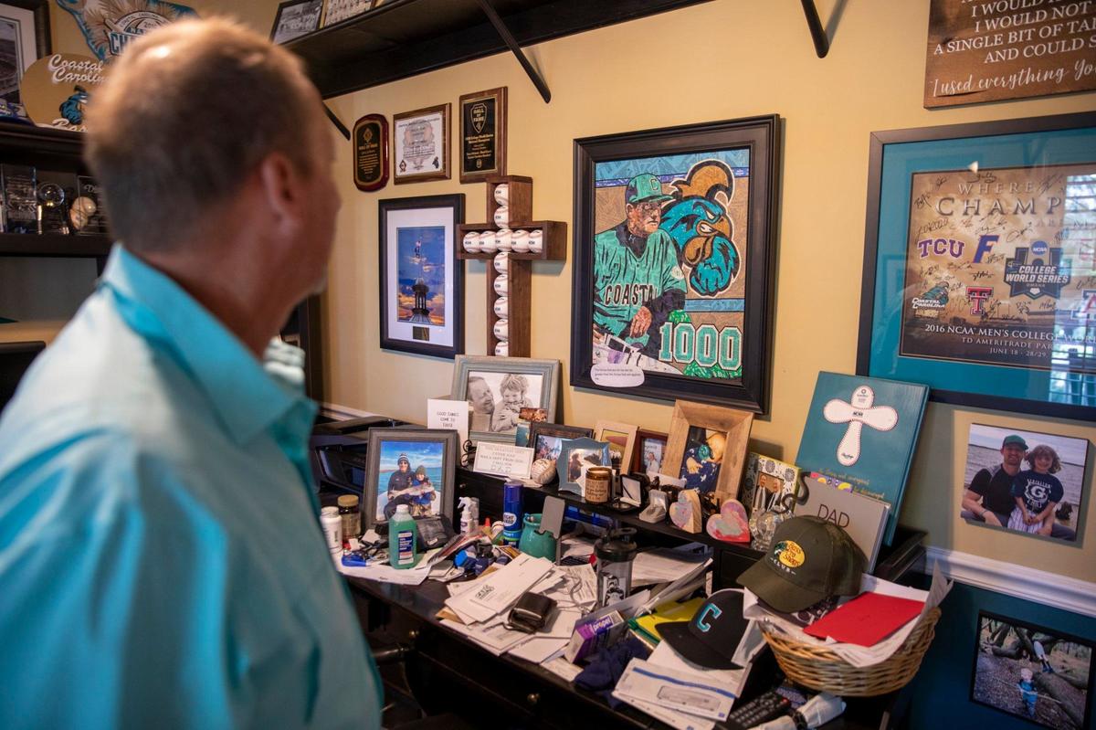 Coastal Carolina Coach Gary Gilmore looks through the memorabilia that fills his office at his North Litchfield Beach home named ‘Poppa’s House’. Gilmore is retiring after 39-years of coaching. May 6, 2024.