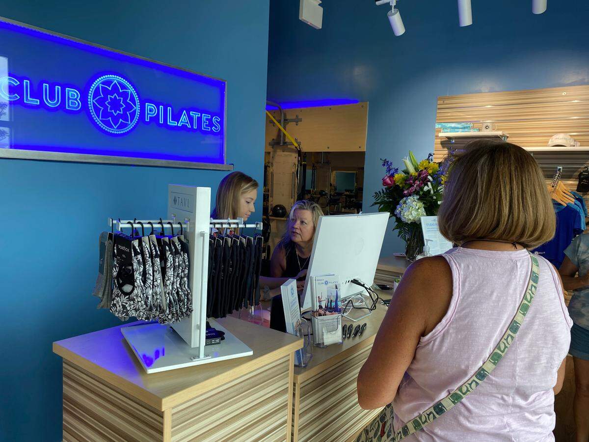 Club Pilates owner Stefanie Josephson, back center, speaks with her instructor Alexandra Brown, left, during a soft opening of the new fitness studio, the first of its kind in the Grand Strand. August 2022.