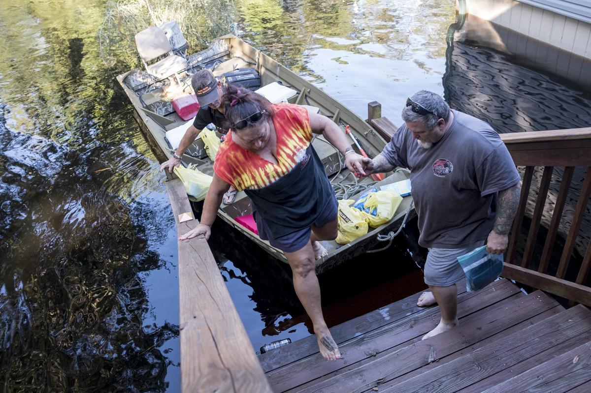 Gina Hanlon her husband Mike arrive to their Lee’s Landing home in a jon boat on Wednesday to check out flood damage. To great relief, the couple found that the flood’s crest had not reached their home’s main level. The Waccamaw River at Conway crested Wednesday at well over 21 feet flooding many downtown homes. Wednesday, Sept. 26, 2018.