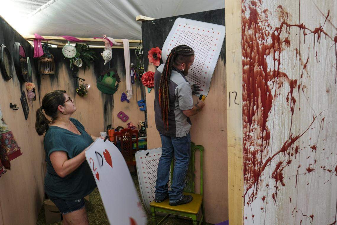 Shanna Coley, owner of Murder Beach Productions, and Donald Safrit, decorate one of the rooms in the company's first haunted attraction. Located near the Conway's S.C. Riverwalk, the haunted house is part of the City of Halloween celebrations. The event features a maze of haunted hallways leading visitors into rooms with different frightening themes. July 18, 2024.