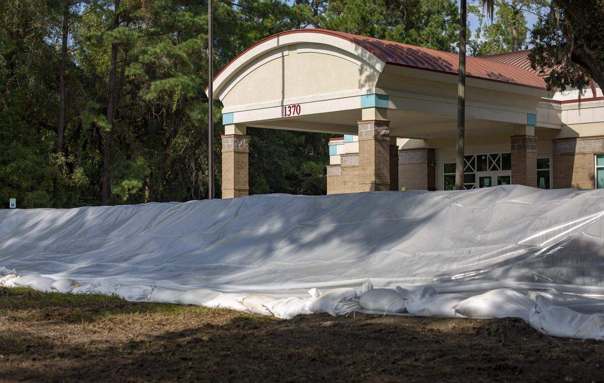 The James R. Frazier Community Center in Bucksport sits surrounded by sandbags and tarps in preparation for the expected flooding of the area Friday.