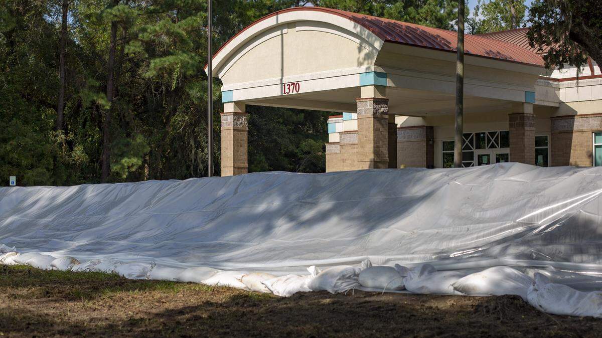 The James R. Frazier Community Center in Bucksport sits surrounded by sandbags and tarps in preparation for the expected flooding of the area Friday.