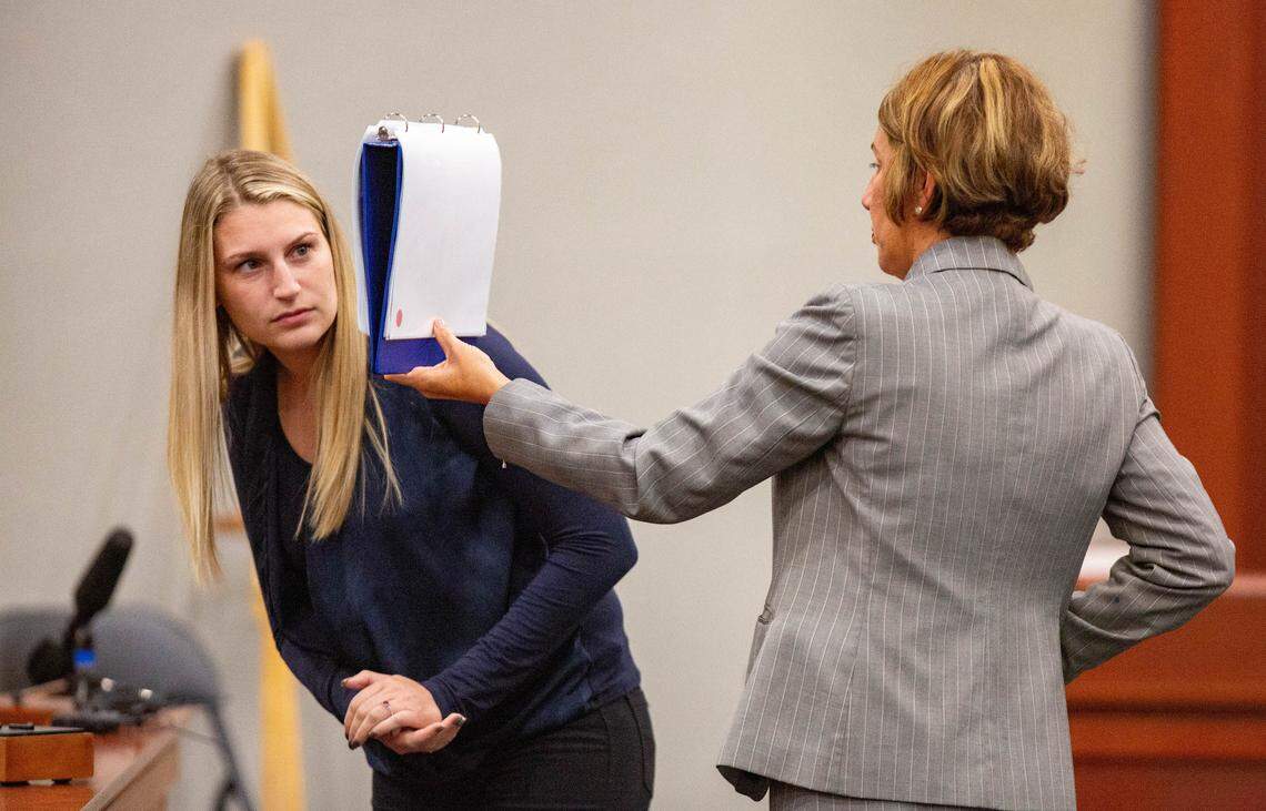 Bri Warrelman looks at photos of her home Tuesday during the trial of Tammy Moorer. Moorer is on trial for kidnapping and conspiracy related to the 2013 disappearance of Heather Elvis. Warrelman was Elvis’s roommate at the time.