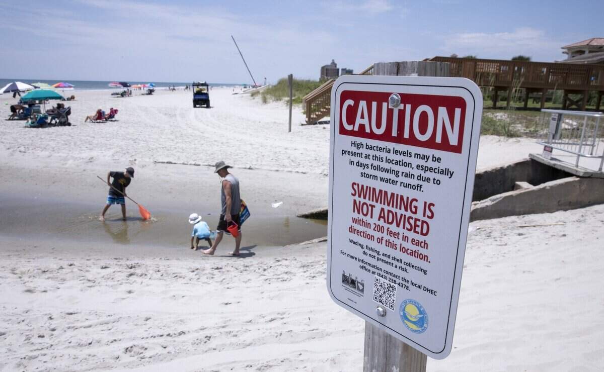 Children play in the Cane Patch Swash in Myrtle Beach. SCDES warns against swimming in swashes and in the outflow of storm water pipes. Long-term swim advisory signs are placed in many areas along the Myrtle Beach coast. June 28, 2018.