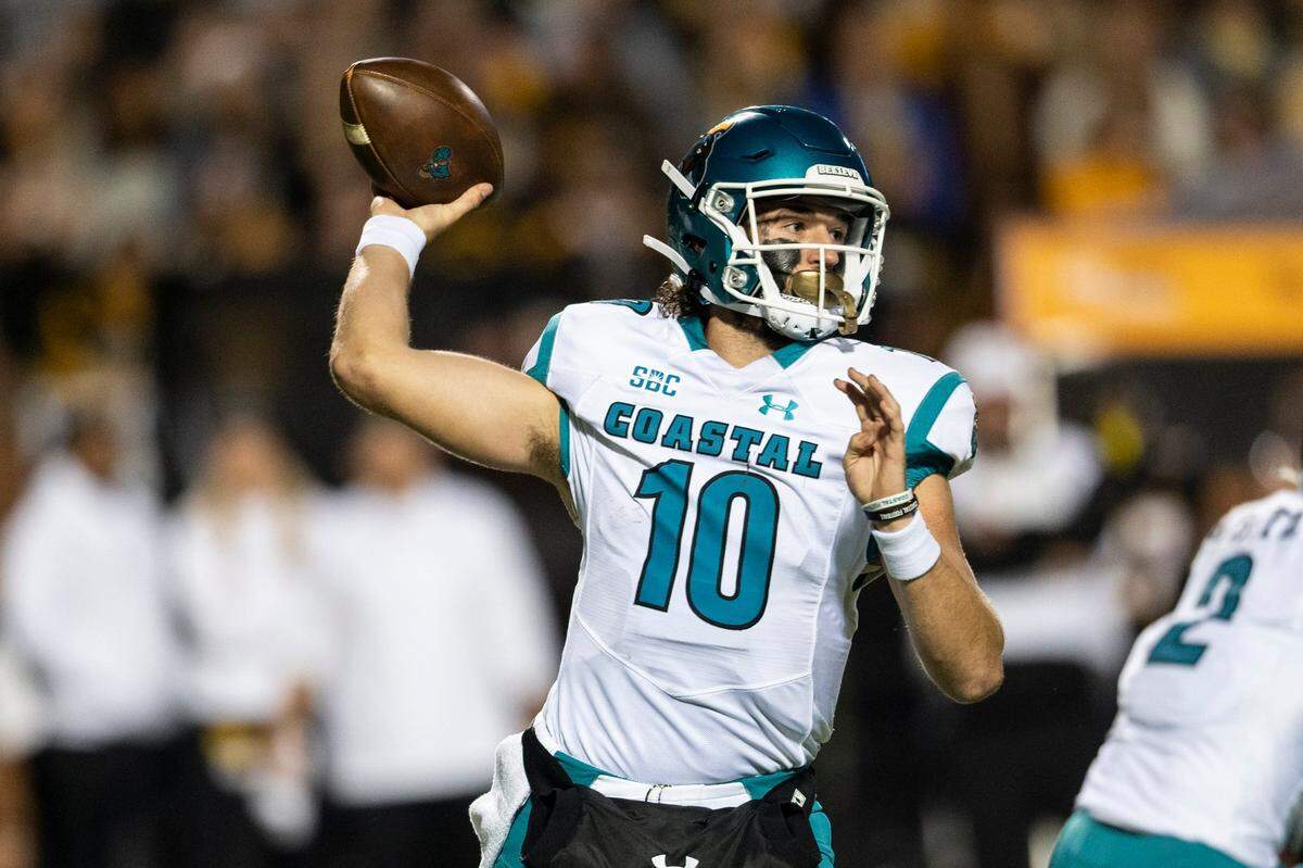 Coastal Carolina quarterback Grayson McCall (10) throws a pass during the first half of the team’s NCAA college football game against Appalachian State on Wednesday, Oct. 20, 2021, in Boone, N.C. (AP Photo/Matt Kelley).