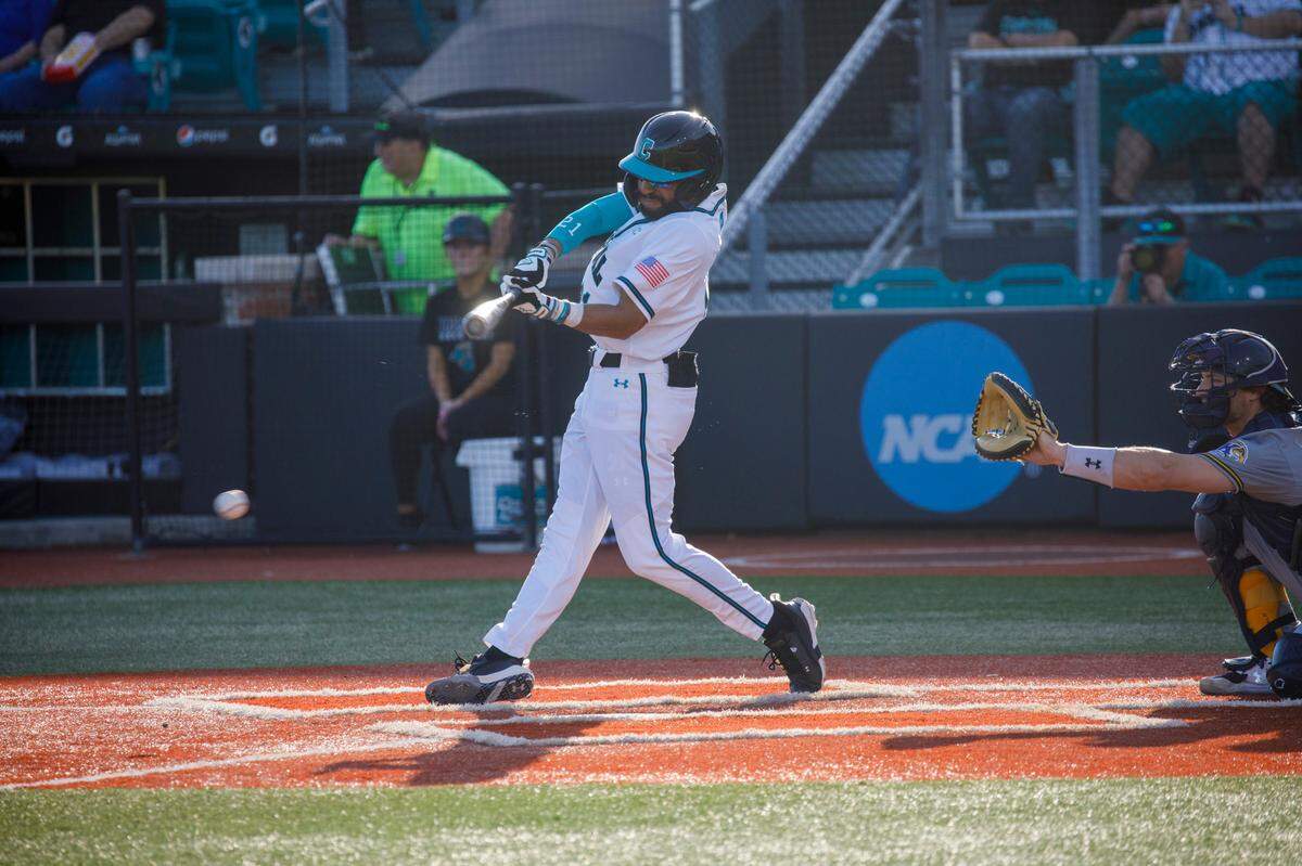Coastal Carolina’s Austin White leads off with a hit against Kent State during the Baseball at the Beach Tournament at Spring Brooks Stadium in Conway on Friday afternoon. February 18, 2022.