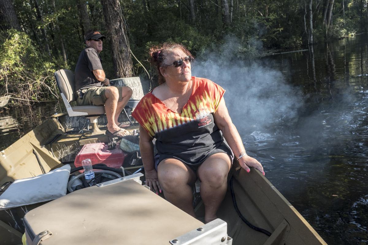 Sierra Abbott takes Gina Hanlon her husband Mike (not pictured) to their Lee’s Landing home in a jon boat on Wednesday. To great relief, the couple found that the flood’s crest had not reached their home’s main level. The Waccamaw River at Conway crested Wednesday at well over 21 feet flooding many downtown homes. Wednesday, Sept. 26, 2018.