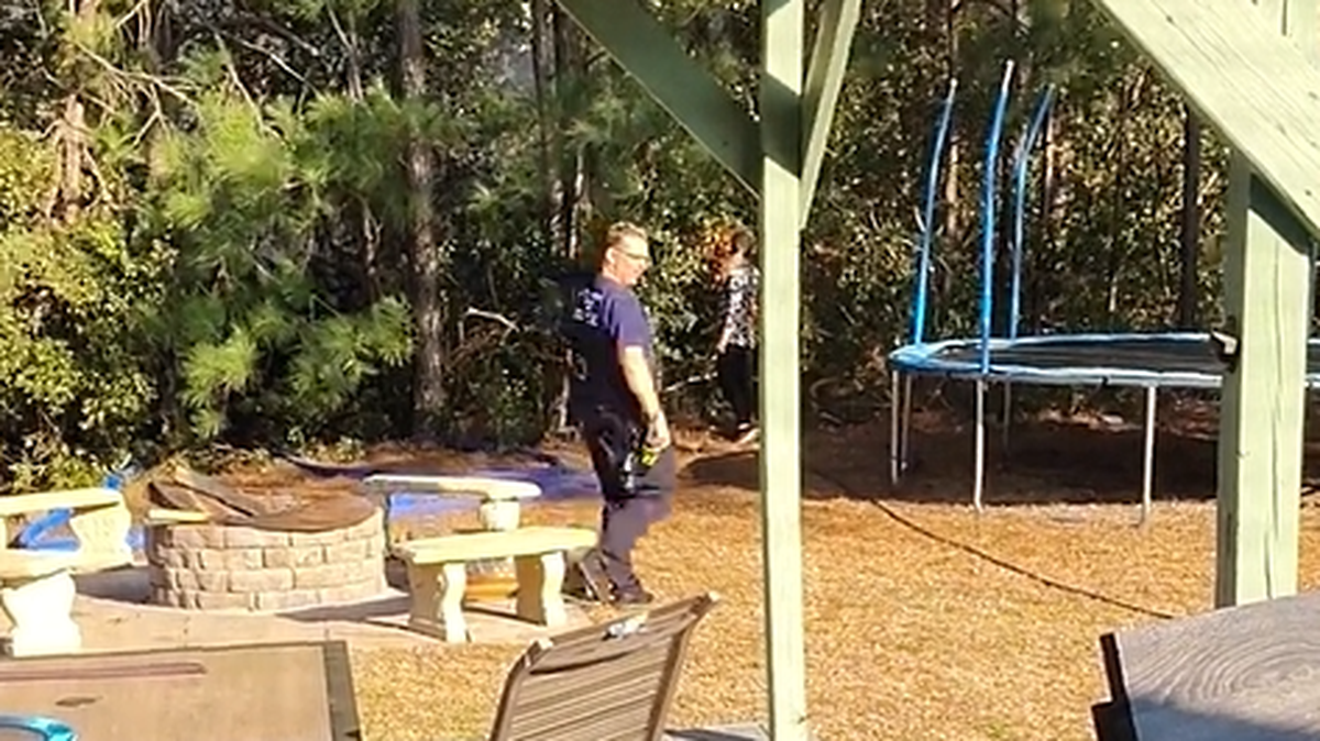 A screen grab from a video taken in the backyard of Alexandra Bialousow, accused of starting a wildfire that spread to more than 2,000-acres in the Myrtle Beach area. The South Carolina Forestry Commission, who arrested her earlier this month, said she didn’t have a hose or an appropriate water source to control the fire.