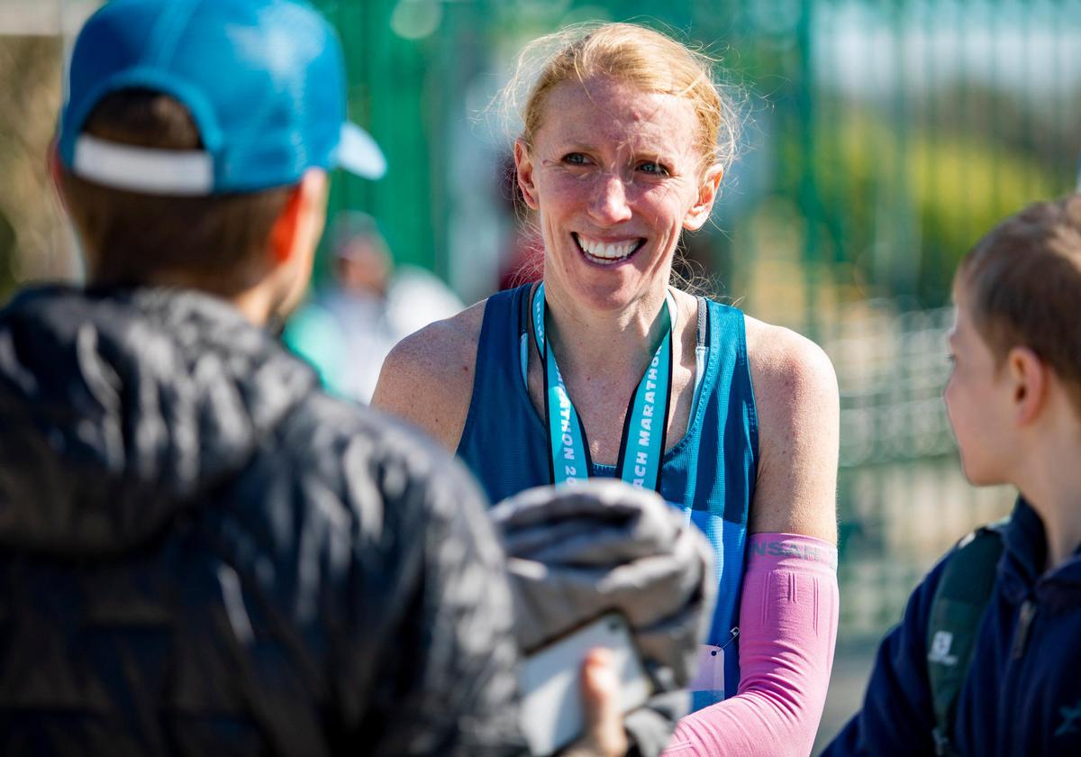Heather Zealand, female winner of the 2020 Myrtle Beach Marathon, chats with her family after winning the race. Zealand won with a time of 2:57:38.