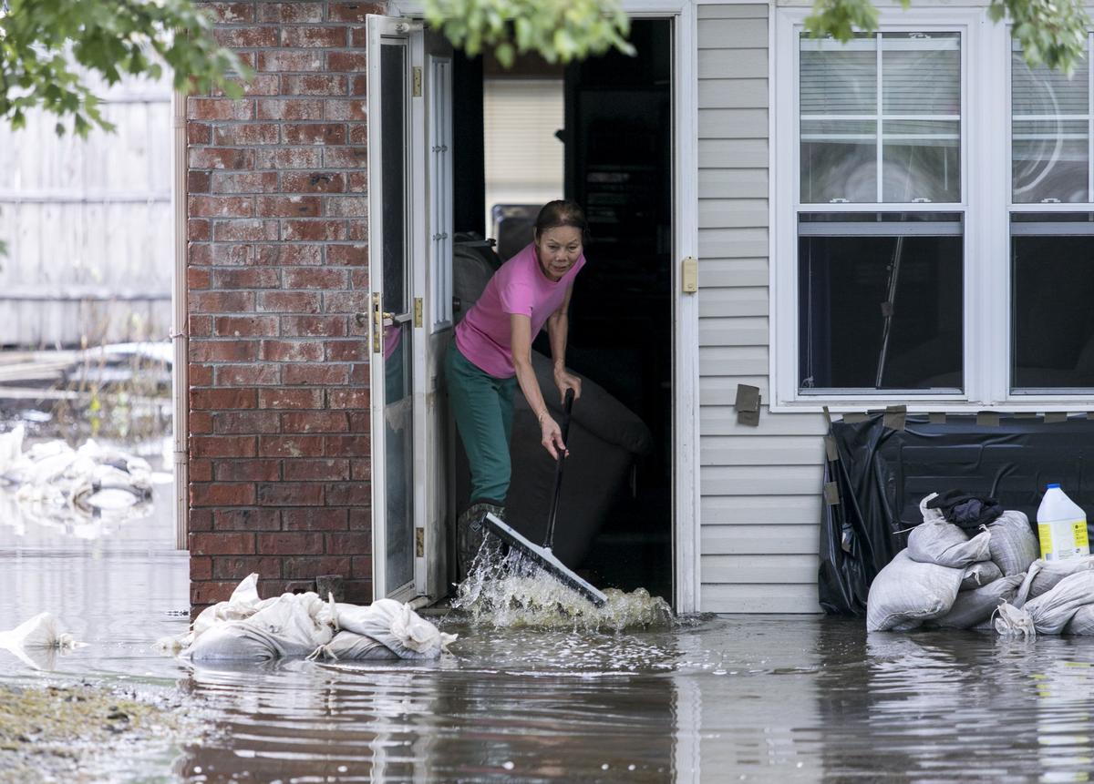 Suay Quandt pushes muddy water from her home in Rosewood. While much of the Rosewood community in Socastee in still under water from Hurricane Florence’s flooding, a few residents were able to return to assess the damage and begin cleaning on Tuesday October 2, 2018.