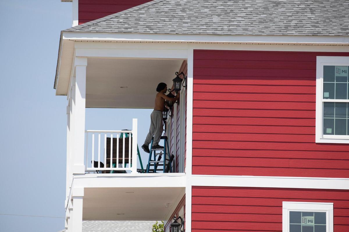 Contractors put the finishing touches on a new home in Atlantic Beach. Atlantic Beach, the small historically black beach town sandwiched between sections of North Myrtle Beach, is undergoing a revitalization according to town manager Benjamin Quattlebaum. New homes are being constructed and oceanfront lots are being marketed to hotels and resorts. June 13, 2022.