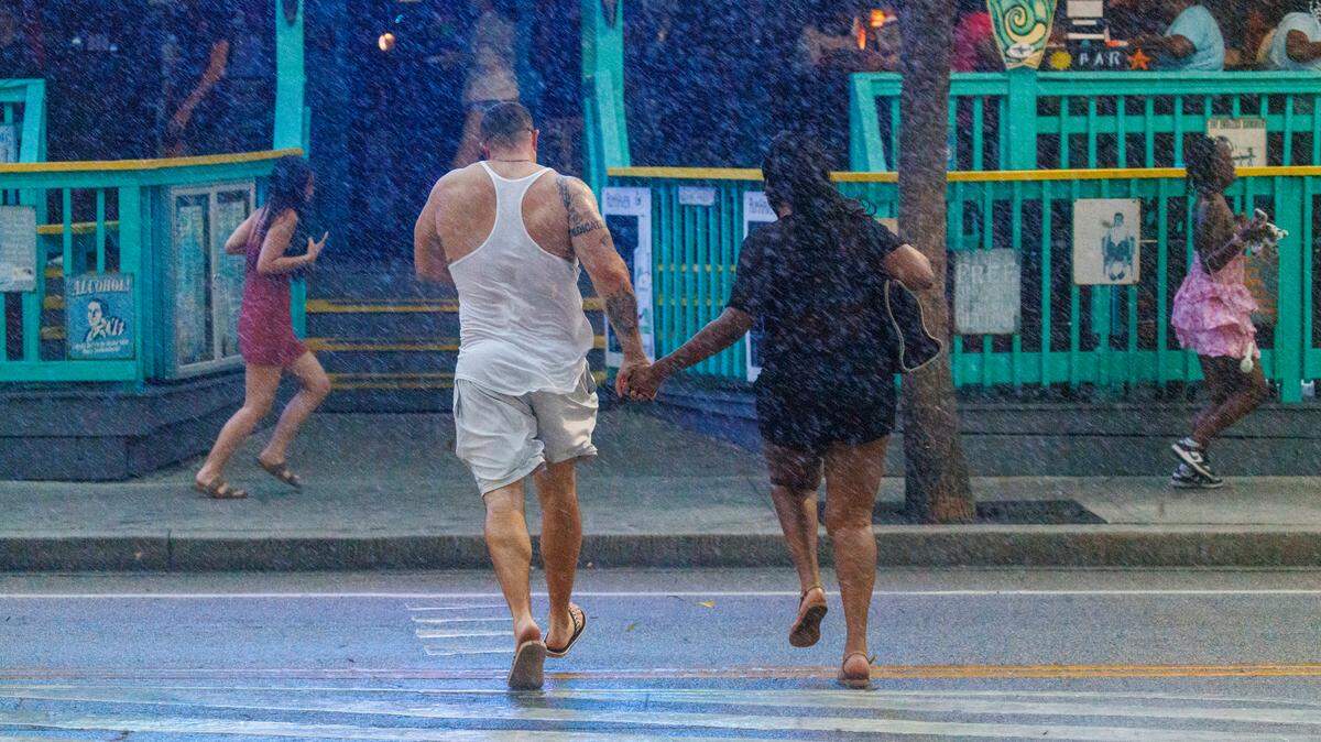 Downtown visitors rush across the street for cover as a summer thunderstorm hits Myrtle Beach, SC on Friday, May 30, 2025. In South Carolina, pedestrians don’t always have the right of way. TSN 2025 File.